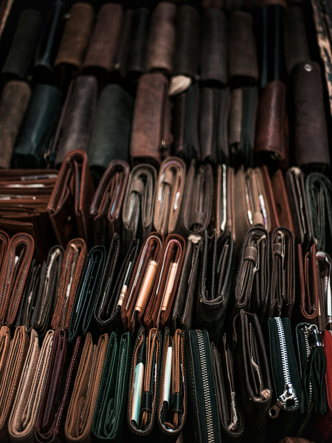 Collection of leather wallets in various colors and designs