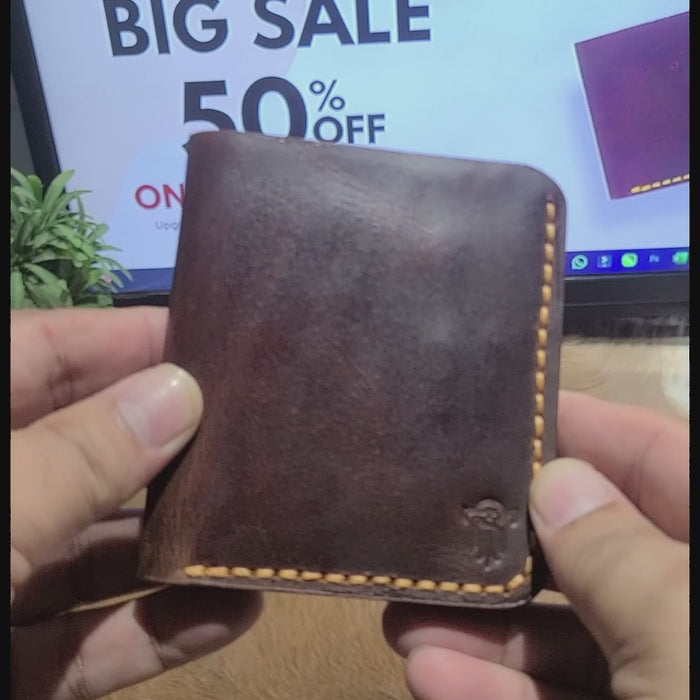 Hand holding brown leather Article No 801 wallet in front of 50% off sale sign. Stylish handcrafted wallet ideal for gifting.
