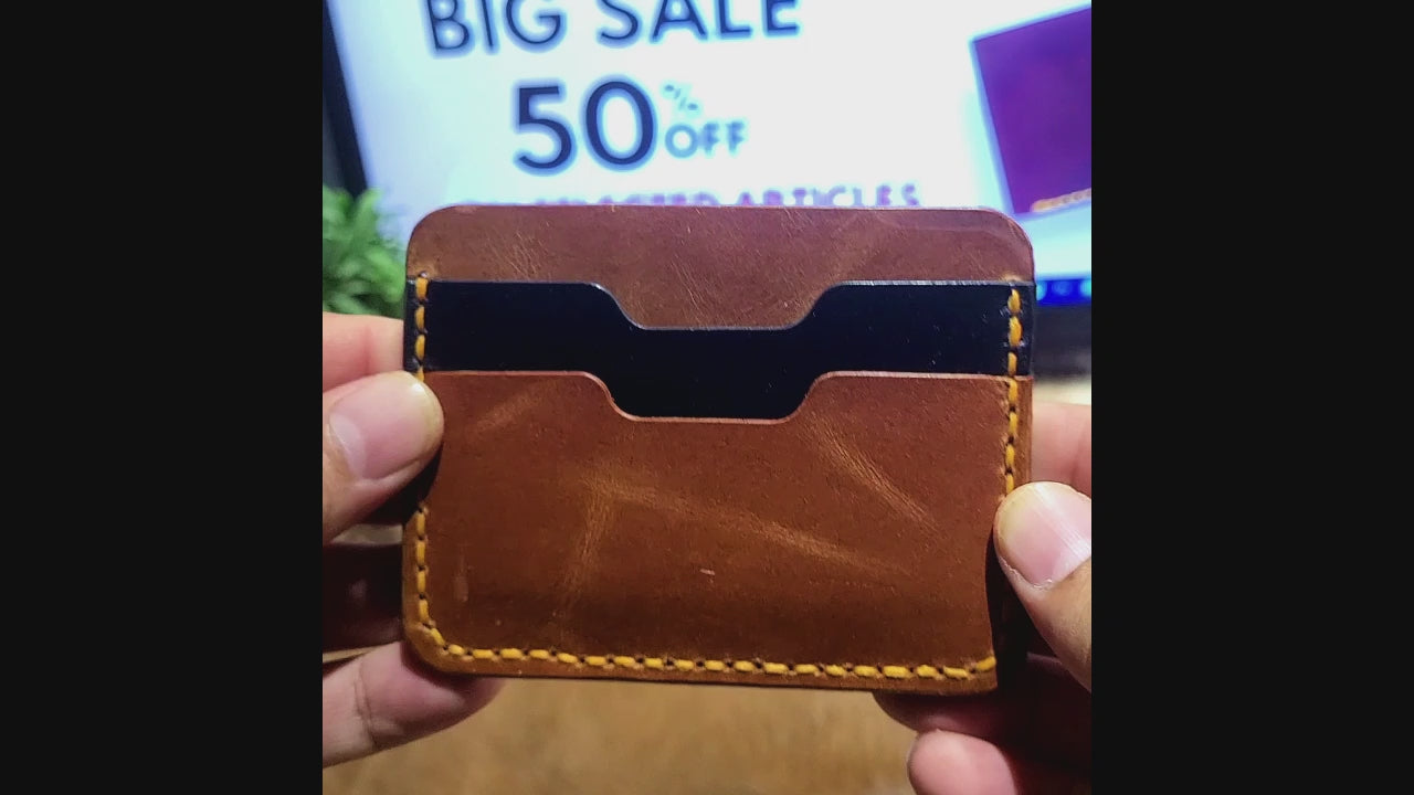 Slim Leather Card Holder Article No 806 in brown with yellow stitching, showcasing two card slots and a minimalist handcrafted design.